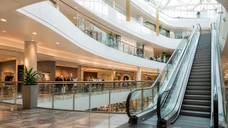 Shopping mall atrium with escalators and retail floors